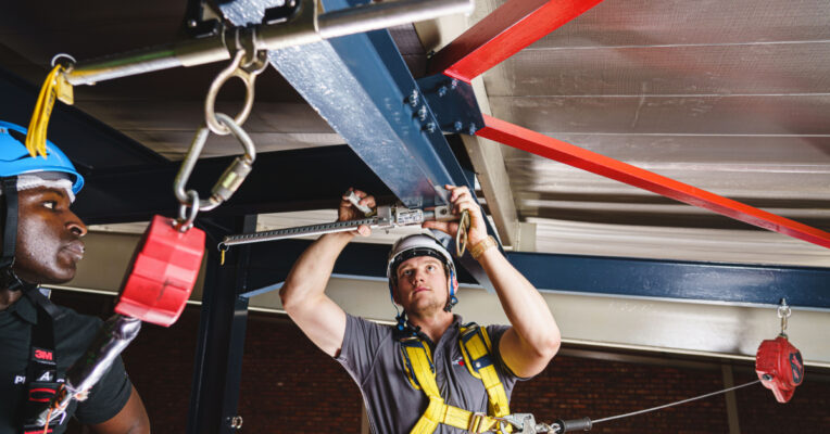Image of man working at heights with roof lifelines and anchor points