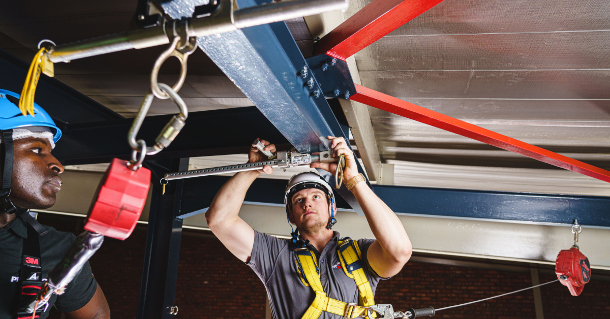 Image of man working at heights with roof lifelines and anchor points